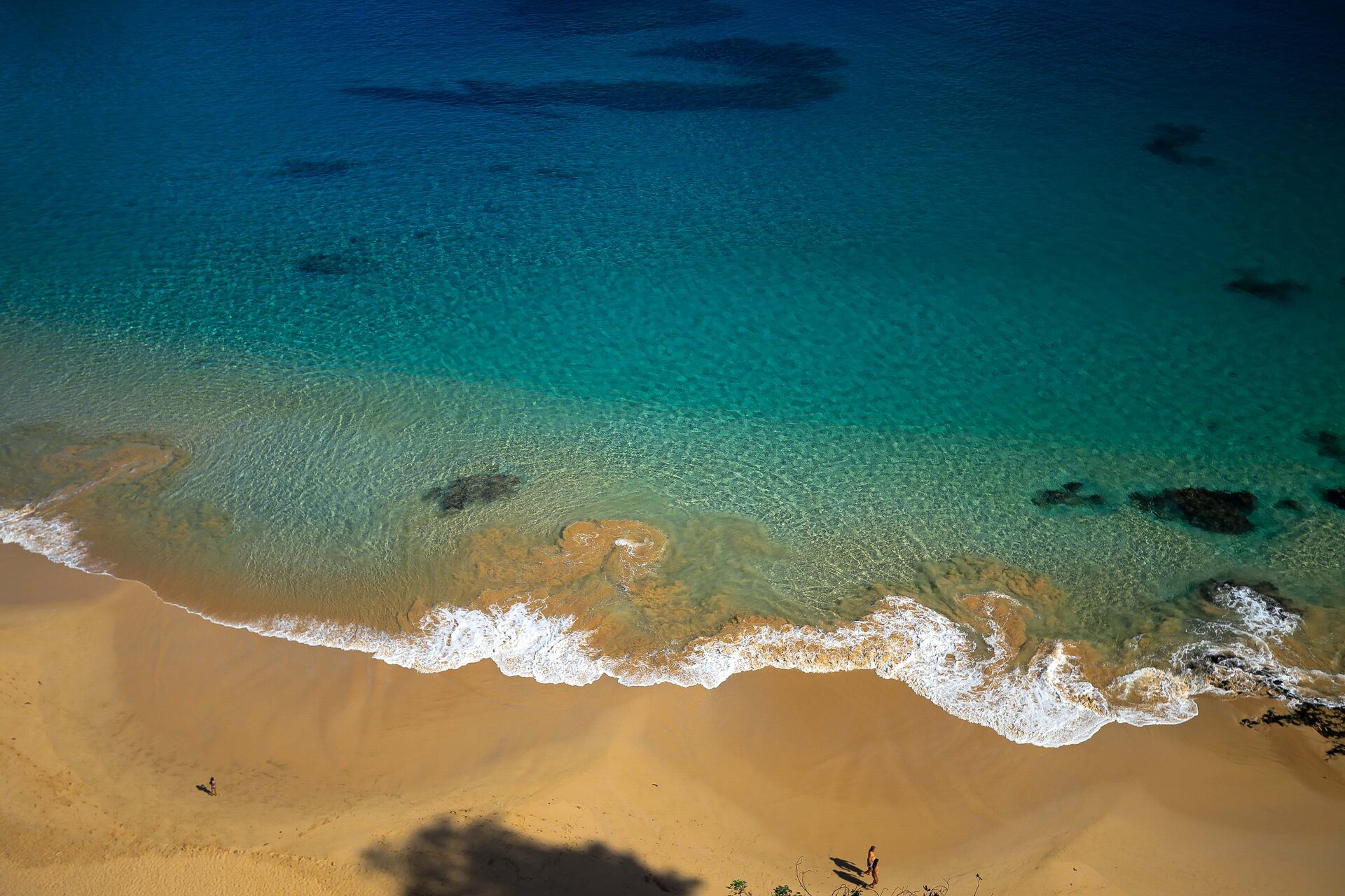 Vista aérea de praia com piscinas naturais